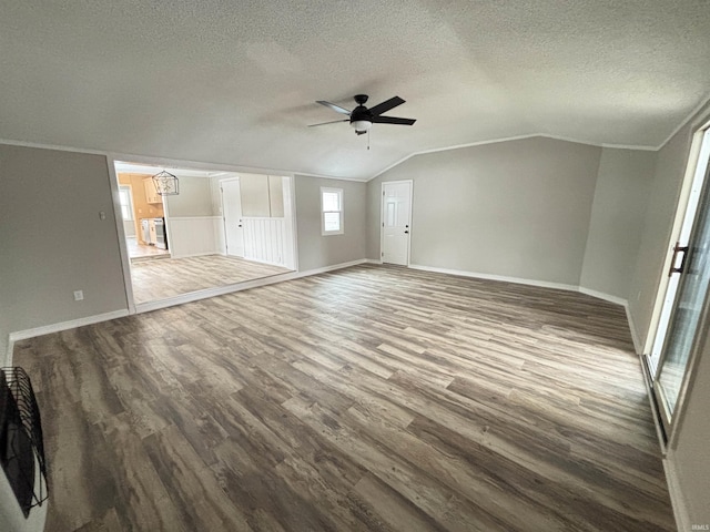 unfurnished living room featuring crown molding, a textured ceiling, lofted ceiling, ceiling fan with notable chandelier, and hardwood / wood-style flooring