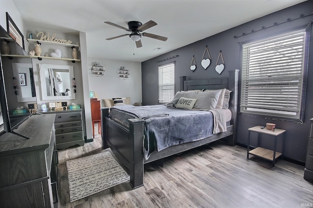 bedroom with ceiling fan and light wood-type flooring