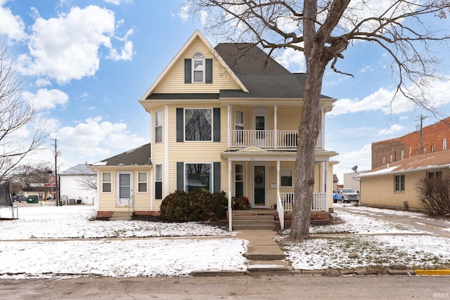 view of front facade with covered porch and a balcony