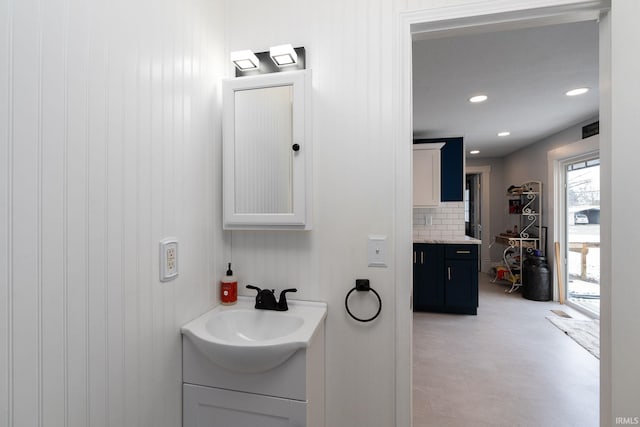 bathroom featuring vanity and backsplash