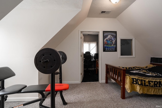 bedroom with carpet, a textured ceiling, and vaulted ceiling