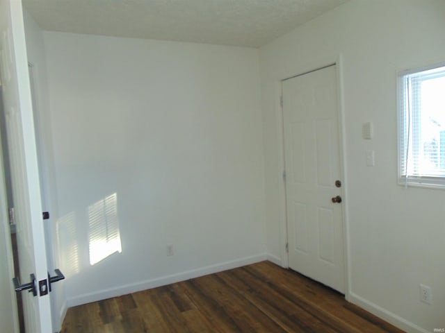 unfurnished room featuring dark hardwood / wood-style flooring