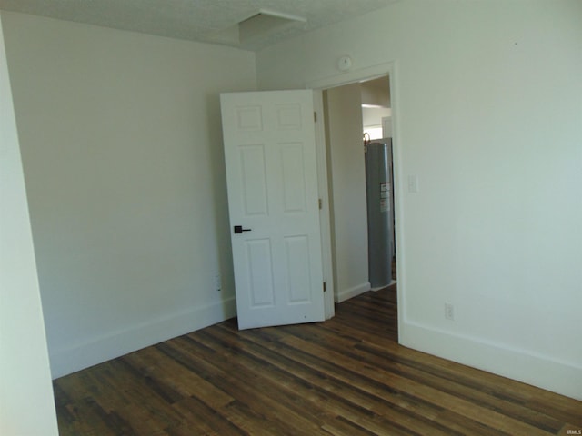 unfurnished room featuring dark wood-type flooring