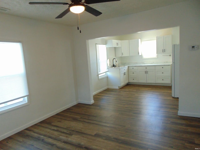 kitchen featuring ceiling fan, sink, dark hardwood / wood-style flooring, white refrigerator, and white cabinets