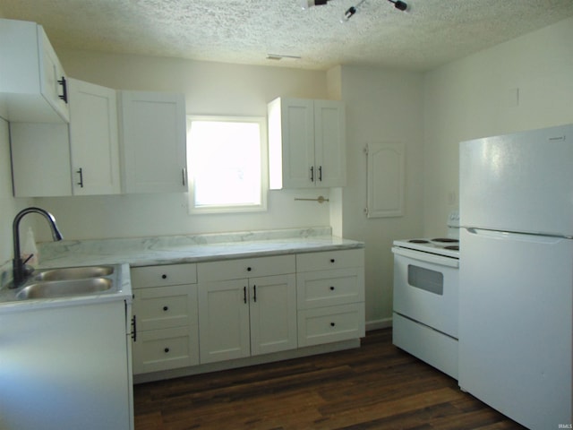 kitchen featuring white appliances, dark wood-type flooring, sink, a textured ceiling, and white cabinetry