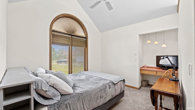 carpeted bedroom with vaulted ceiling and ceiling fan