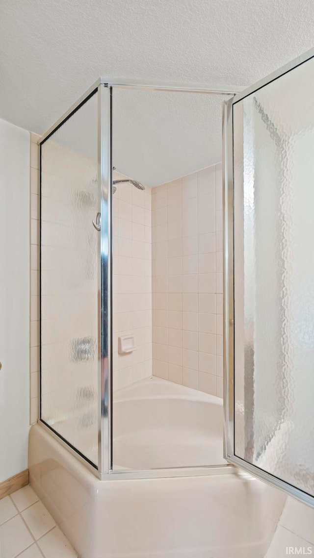 bathroom featuring tile patterned floors and a textured ceiling