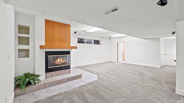 unfurnished living room with carpet flooring and a fireplace