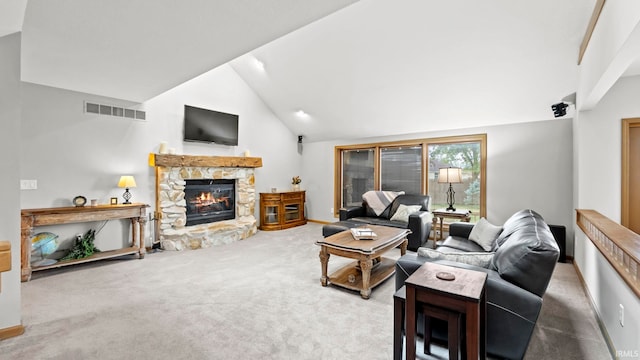 carpeted living room with high vaulted ceiling and a stone fireplace