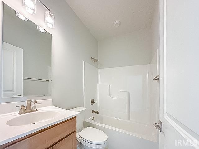 full bathroom with vanity, shower / bath combination, and toilet