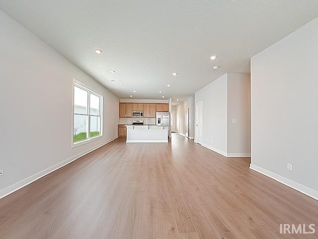 unfurnished living room with light hardwood / wood-style flooring