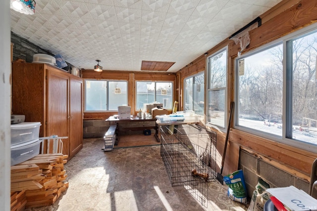 sunroom featuring a water view and plenty of natural light