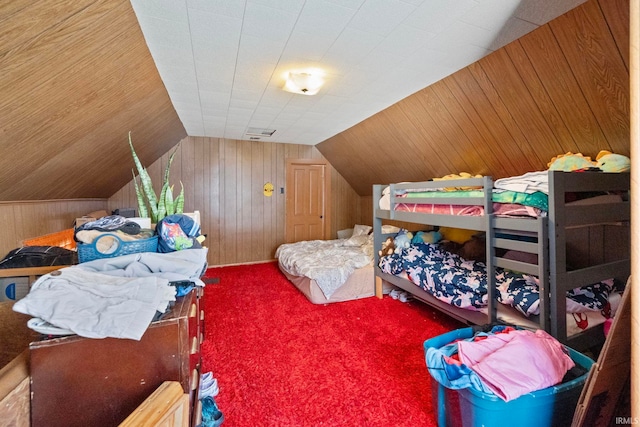 carpeted bedroom featuring wood walls and lofted ceiling