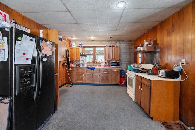 kitchen with black fridge with ice dispenser, white gas range oven, dark carpet, and wood walls