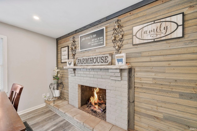 details with a fireplace, hardwood / wood-style flooring, and wooden walls