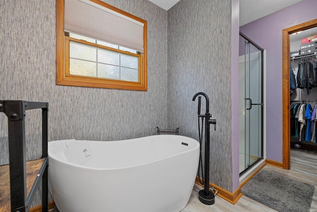 bathroom with hardwood / wood-style floors and separate shower and tub