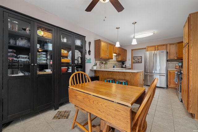 tiled dining area with ceiling fan