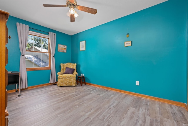 sitting room featuring ceiling fan and light hardwood / wood-style floors