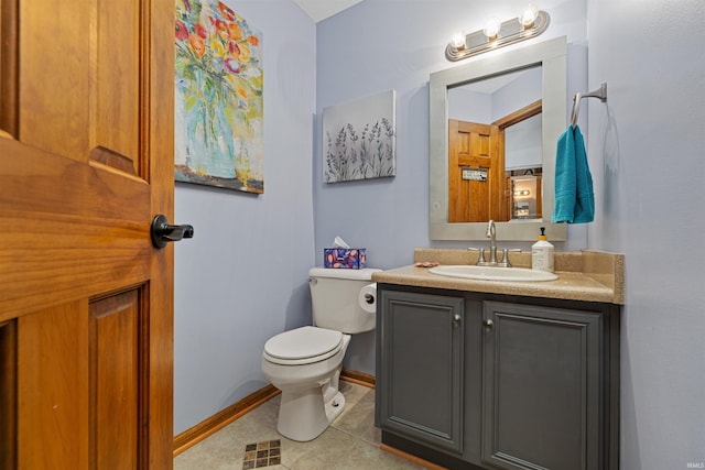 bathroom featuring tile patterned flooring, vanity, and toilet