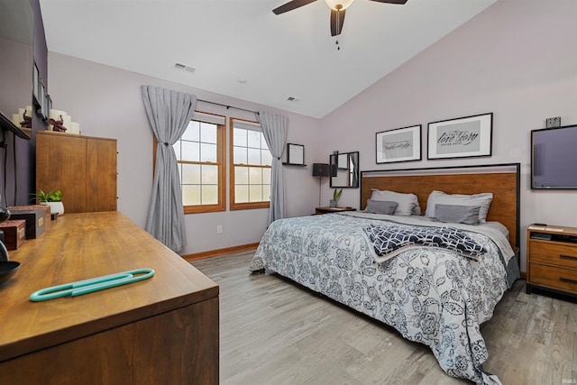 bedroom with ceiling fan, light hardwood / wood-style floors, and lofted ceiling