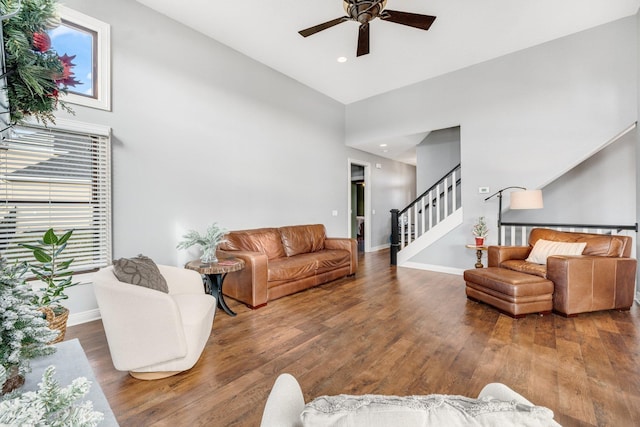 living room with wood-type flooring, high vaulted ceiling, and plenty of natural light