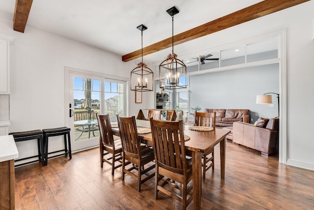 dining room with beamed ceiling, ceiling fan with notable chandelier, and dark hardwood / wood-style flooring