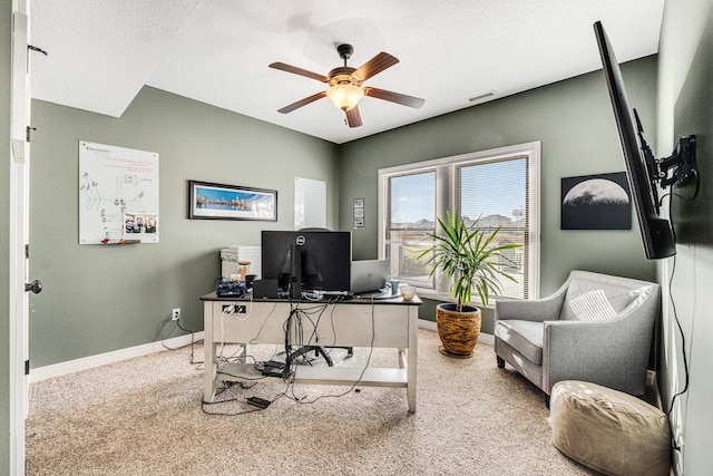 carpeted office featuring ceiling fan and a textured ceiling