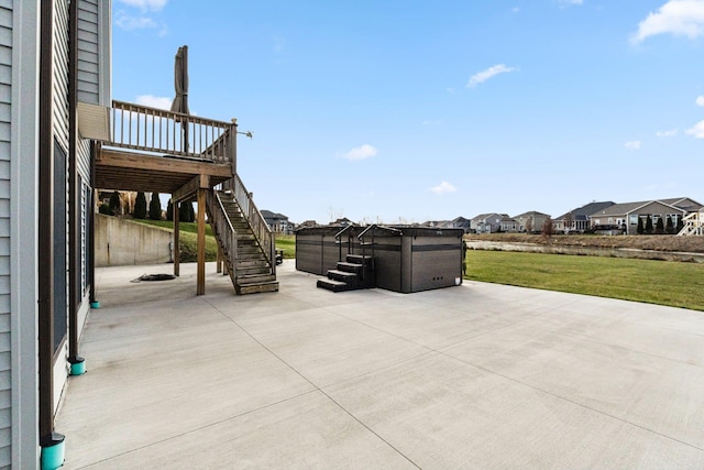 view of patio with a deck and a hot tub