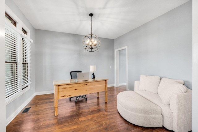 office with dark hardwood / wood-style floors and an inviting chandelier