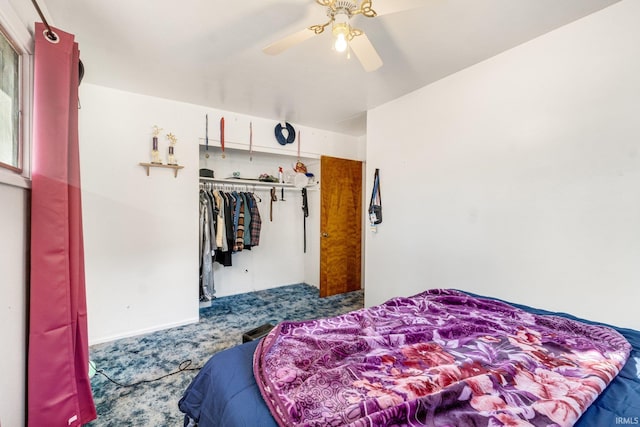 carpeted bedroom with ceiling fan and a closet