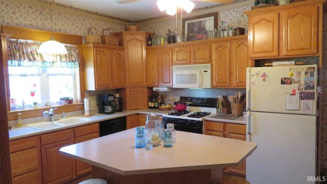 kitchen featuring white appliances, a center island, ceiling fan, and sink