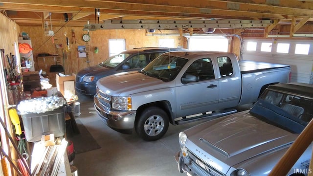 garage with a garage door opener and wood walls