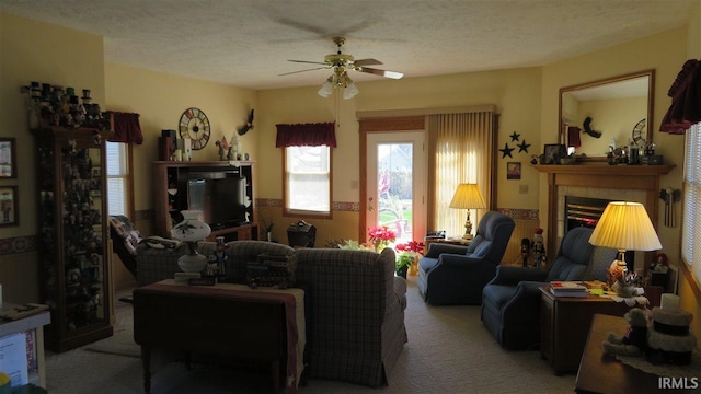 living room featuring light carpet, a textured ceiling, and ceiling fan