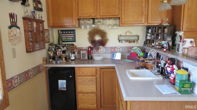 kitchen featuring fridge and sink