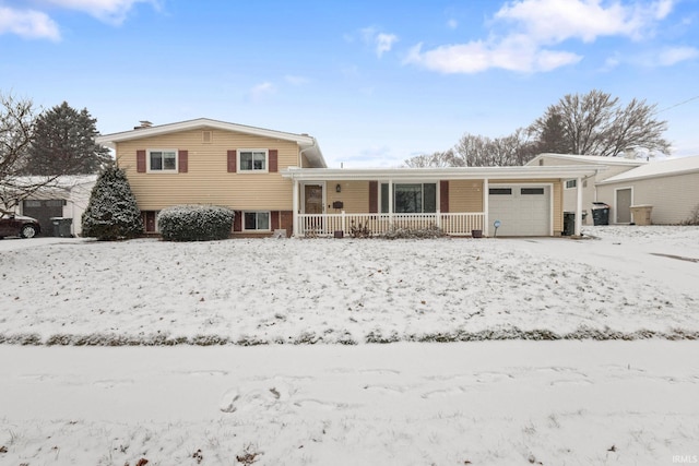 snow covered property with a garage