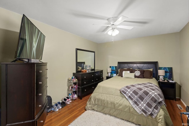 bedroom with ceiling fan and dark wood-type flooring