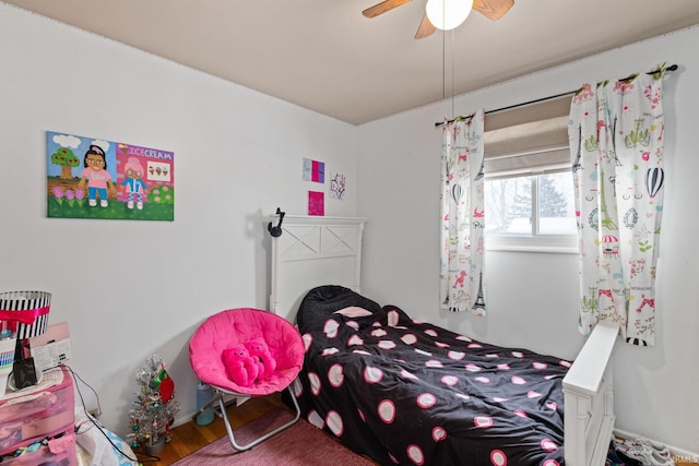 bedroom with ceiling fan and hardwood / wood-style flooring