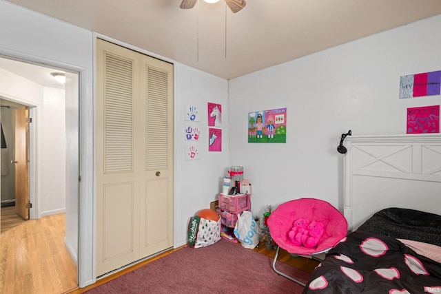 bedroom featuring hardwood / wood-style floors, a closet, and ceiling fan