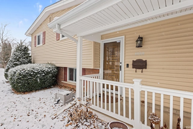 view of snow covered property entrance