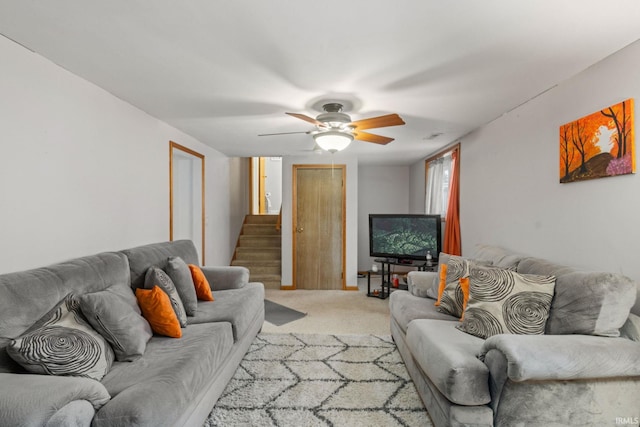 carpeted living room with ceiling fan