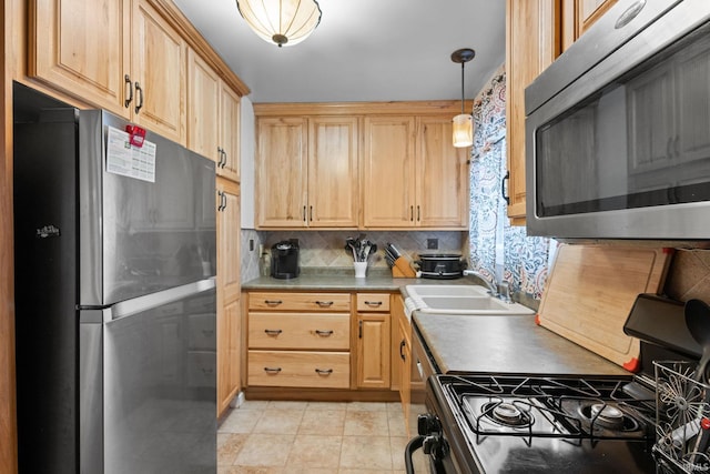 kitchen with decorative backsplash, stainless steel appliances, sink, pendant lighting, and light tile patterned floors