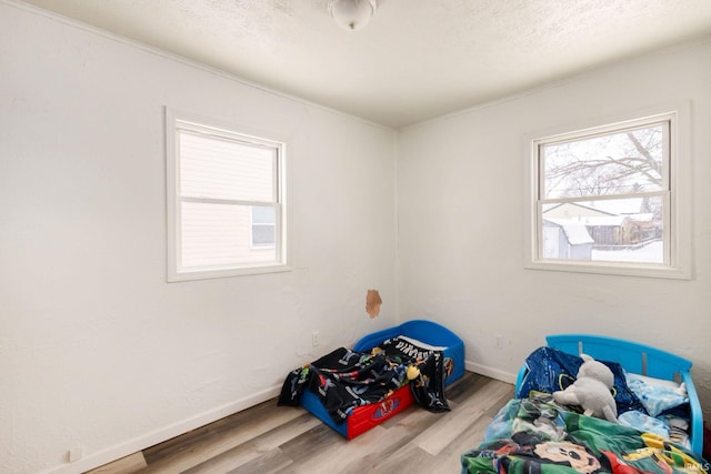 bedroom featuring a textured ceiling and hardwood / wood-style flooring