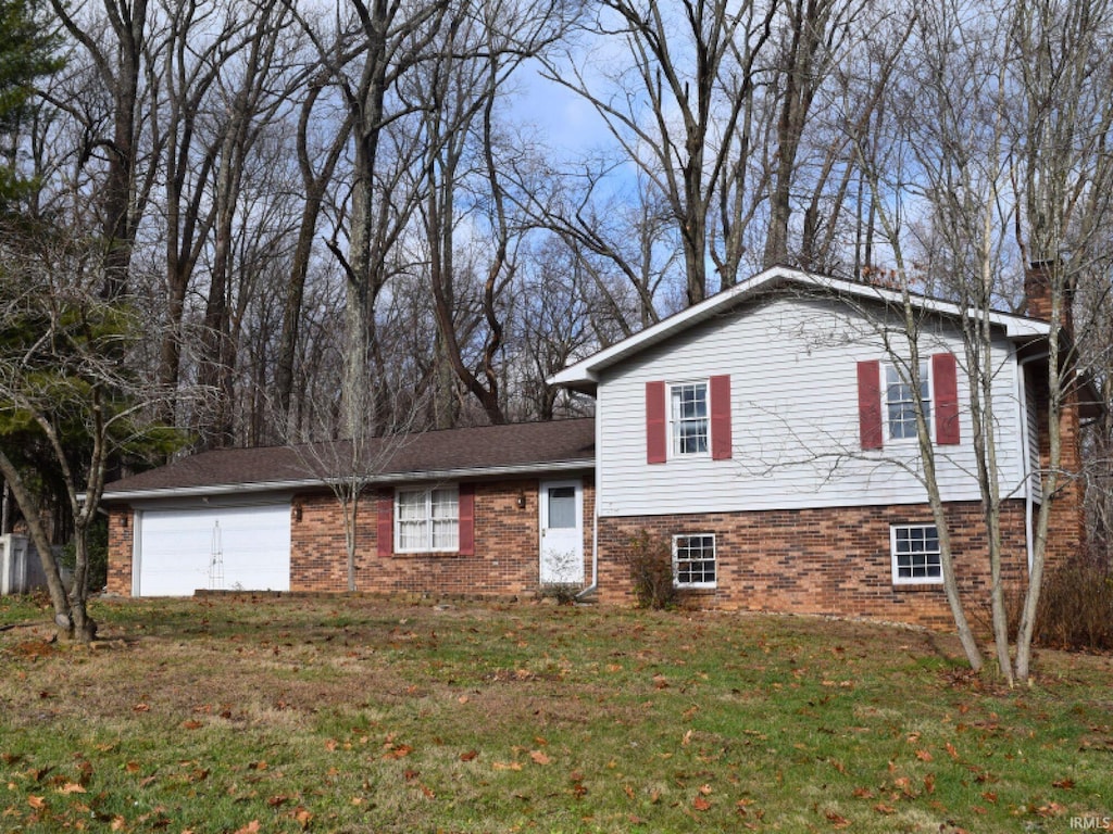 split level home with a garage and a front yard