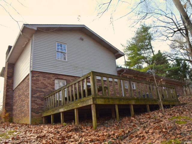 back of property featuring a wooden deck