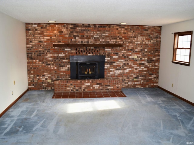 unfurnished living room featuring dark colored carpet, a textured ceiling, and a wood stove