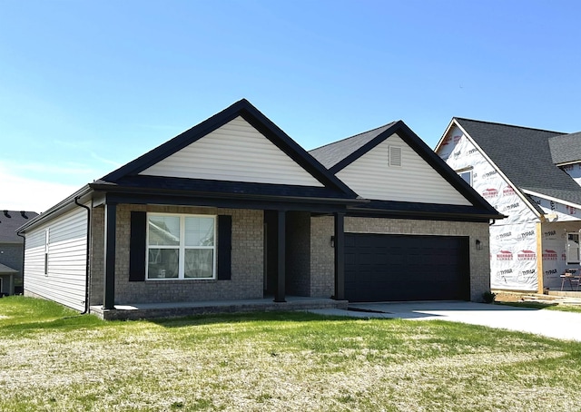 view of front of home with a porch, a garage, and a front yard