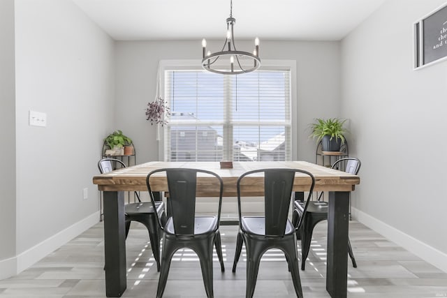 dining room featuring light hardwood / wood-style floors and a notable chandelier