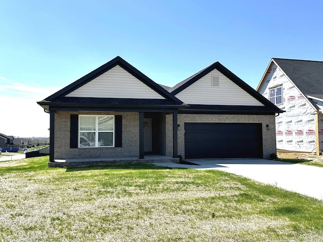 view of front of property featuring a garage and a front lawn