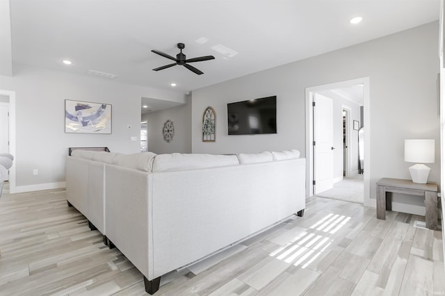 living room with ceiling fan and light wood-type flooring