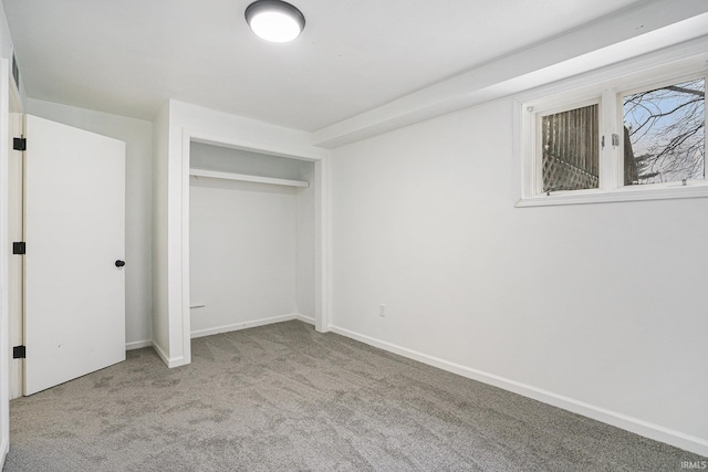 unfurnished bedroom with light carpet and a closet